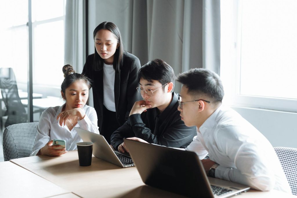 a group of people having a meeting in the office