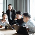 a group of people having a meeting in the office