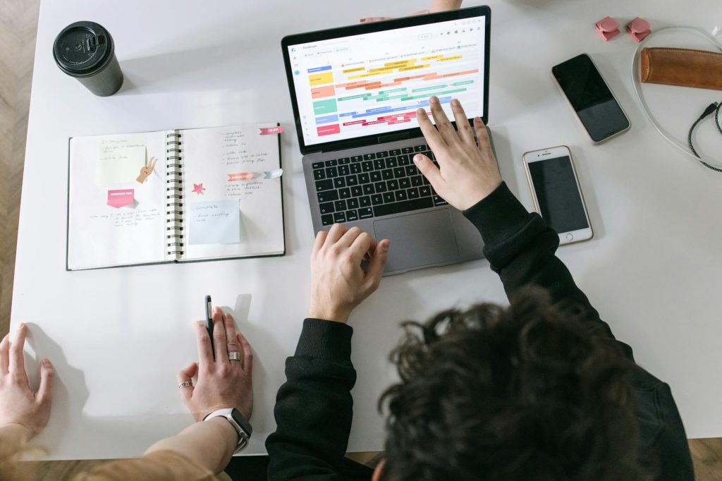person in black long sleeve shirt using macbook pro