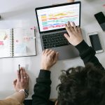 person in black long sleeve shirt using macbook pro